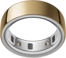 A gold and silver Oura Ring with a smooth gold exterior and a silver interior featuring multiple small sensors and contact points.