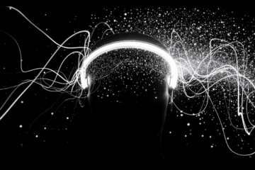 A glowing pair of headphones on a dark background with swirling white lines and particles radiating outward, suggesting music, sound waves, or creative energy, perfect for a Muse Headband review backdrop.